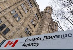 Canada Revenue Agency sign in front of a historic stone building