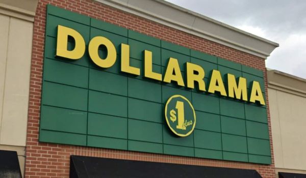 Dollarama storefront with bold yellow 'DOLLARAMA' lettering on a green panel facade and a circular $1 sign below.