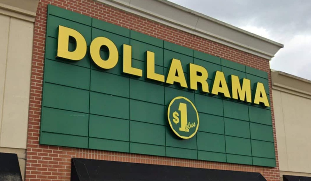 Dollarama storefront with bold yellow 'DOLLARAMA' lettering on a green panel facade and a circular $1 sign below.