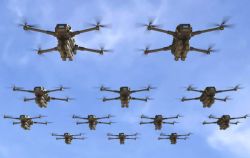 Twelve quadcopter drones flying in a loose grid formation against a clear blue sky.