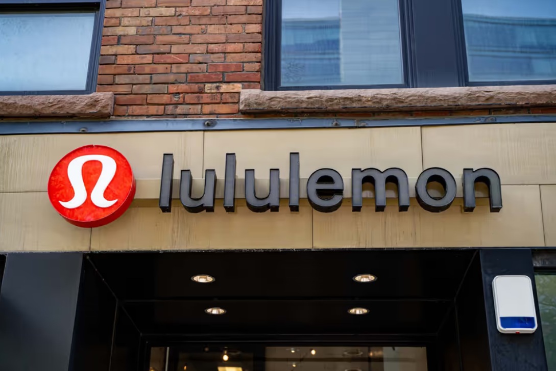 Lululemon storefront with red circular logo and bold black letters on beige facade