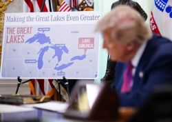 Map of the Great Lakes region on an easel, with a sign reading 'Making the Great Lakes Even Greater' and labels for Lake Superior, Michigan, Huron, Erie, and a pink callout 'Lake America'.