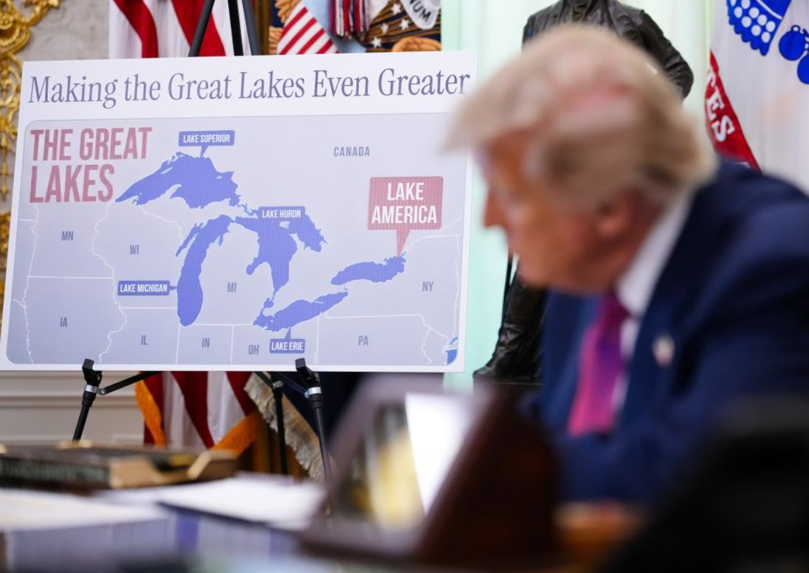 Map of the Great Lakes region on an easel, with a sign reading 'Making the Great Lakes Even Greater' and labels for Lake Superior, Michigan, Huron, Erie, and a pink callout 'Lake America'.