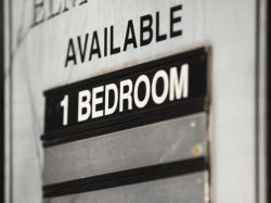 Sign on a door stating 'Available 1 Bedroom' for a rental apartmentemporary.