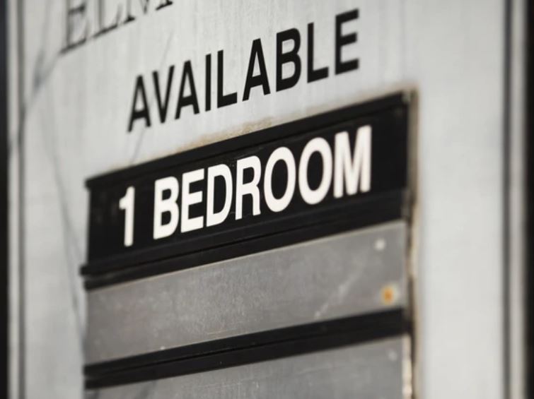 Sign on a door stating 'Available 1 Bedroom' for a rental apartmentemporary.