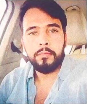 Рохит Годара | Наш Ванкувер Man with dark hair and beard taking a selfie in a car, wearing a light-blue shirt and looking at the camera.