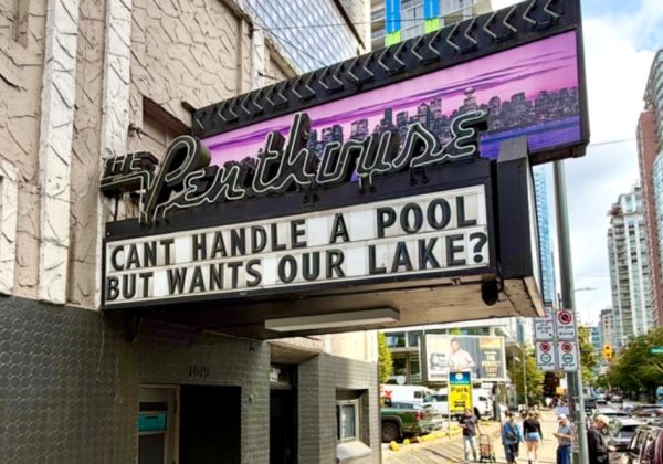 The Penthouse marquee outside a city building, with the sign reading: "CANT HANDLE A POOL BUT WANTS OUR LAKE?" pedestrians and street scene in the background.