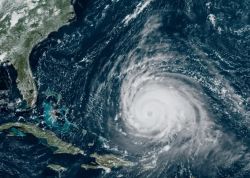 Satellite image of a massive hurricane with a well-defined eye approaching the Caribbean, near Cuba and Florida.
