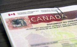 Close-up of a Canadian immigration document showing the word CANADA and official header text "Immigration, Refugees and Citizenship Canada".