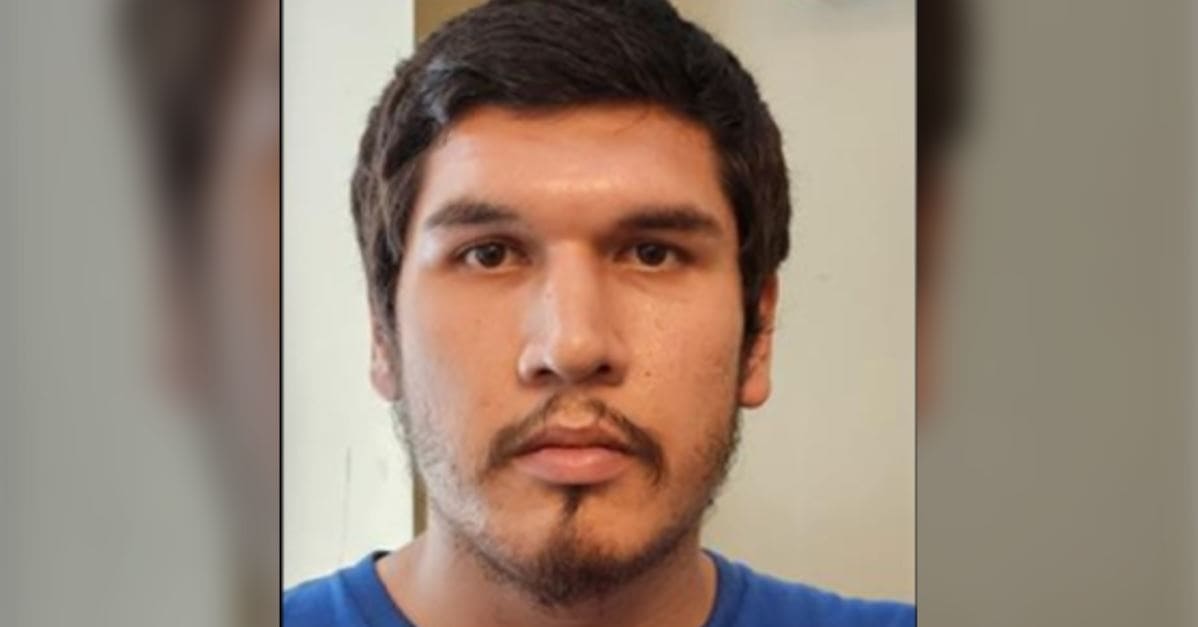 Полиция Ванкувера | Наш Ванкувер Close-up portrait of a young man with dark hair and facial hair, wearing a blue shirt, looking at the camera with a neutral expression.